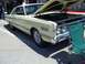 1970 Ford Ranchero - Pale yellow 1967 Mercury Cougar parked outdoors with its hood raised.
