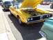 1970 Ford Ranchero - A yellow 1971 Dodge Charger SE is parked with its hood open, showing the engine bay.
