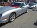 1970 Ford Ranchero - A silver sports car with a red interior is parked on asphalt, with another car visible behind it.