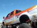 1970 Ford Ranchero - This lifted pickup truck features custom orange and silver flame graphics along its bodywork.