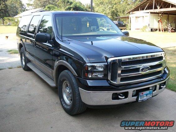 Black 2001 Ford Excursion parked on a concrete driveway