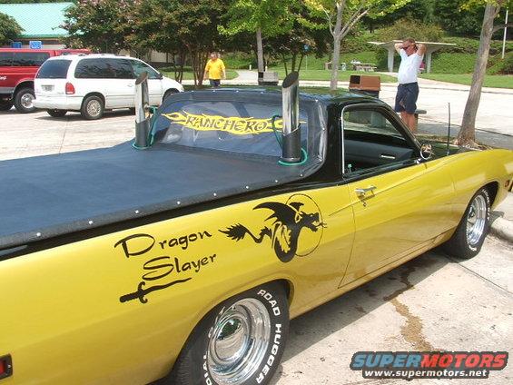 Yellow 1972 Ford Ranchero with 'Dragon Slayer' graphics and dual exhaust stacks