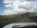 1996 Ford Bronco - Driving on a dirt road through a vast, open landscape with mountains on the horizon.
