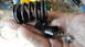 1973 Ford Torino - Broken valve spring and retainer pieces held in a dirty hand.