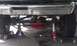1979 Ford Bronco - Front suspension parts are visible, including shocks and steering linkage, under a chrome bumper.