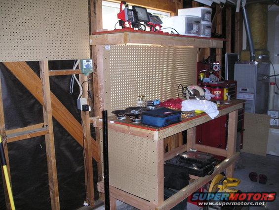 Workbench with tools, pegboard, and storage shelves
