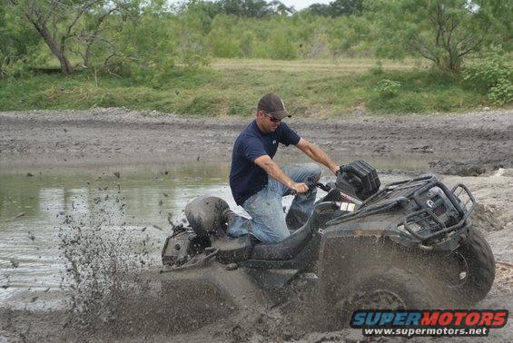 ATV stuck in mud with rider