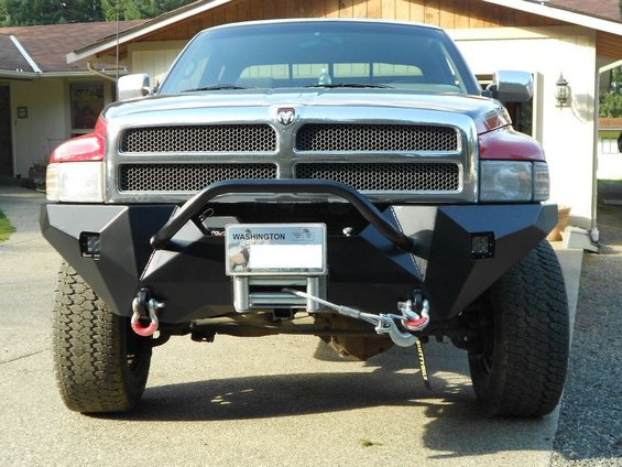 Front view of a Dodge Ram truck with an aftermarket bumper, winch, and tow hooks. Washington license plate visible