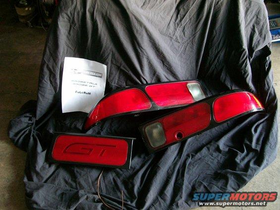 Car tail lights and a GT emblem on a black cloth
