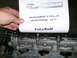 1995 Ford Probe - A document with "PROBETALK PROBE GT" is held over a car engine part.
