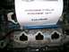 1995 Ford Probe - Close-up of an engine manifold with a paper displaying text related to a Ford Probe GT.