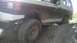 1989 Ford Bronco - This vehicle is covered in mud from off-roading on a dirt trail.