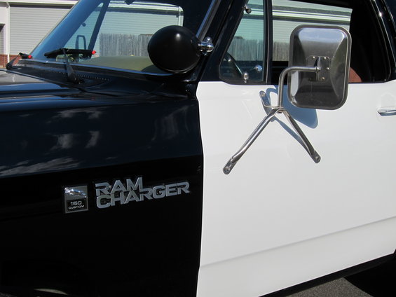 Black and white two-tone 1987 Dodge 1500 Ramcharger side view with chrome mirrors