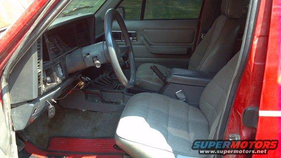 1995 Jeep Cherokee interior showing front seats, dashboard, steering wheel, and center console