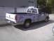 2003 Ford Crown Victoria - Chevrolet pickup truck with primer finish is parked outdoors.
