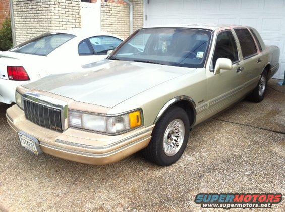 1997 Lincoln Town Car parked in driveway next to another car