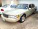 1997 Lincoln Town Car - A 1997 Lincoln Town Car is parked outside a garage, with another vehicle visible to its left.