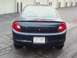 2000 Dodge Neon - Rear view of a dark blue sedan with dual exhaust pipes and a Wisconsin license plate.