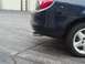 2000 Dodge Neon - Close-up of a car's rear section, showing the taillight and exhaust pipe.