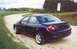 2000 Dodge Neon - Dark blue 2000 Dodge Neon sedan seen from the rear on a dirt road.