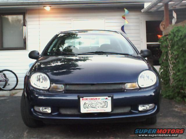 Dark blue 2000 Dodge Neon parked in front of a white house, front view