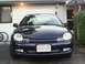 2000 Dodge Neon - A dark blue 2000 Dodge Neon is parked in front of a residential building.