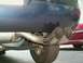 2000 Dodge Neon - Close-up view of the dual exhaust pipes on the rear of a dark blue vehicle, with another car partially visible.