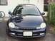 2000 Dodge Neon - The front of a dark blue Dodge Neon is shown parked in front of a house.