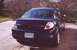 2000 Dodge Neon - Rear view of a dark blue 2000 Dodge Neon sedan parked outdoors. The vehicle features a spoiler and a Wisconsin license plate.