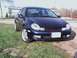 2000 Dodge Neon - Front view of a dark blue 2000 Dodge Neon sedan parked on a grassy area.