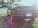 2000 Dodge Neon - The rear of a dark sedan, identified as a 2000 Dodge Neon, is shown from a low angle.