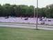 2000 Dodge Neon - A variety of vehicles are parked in an outdoor lot, with a line of trees visible behind them.