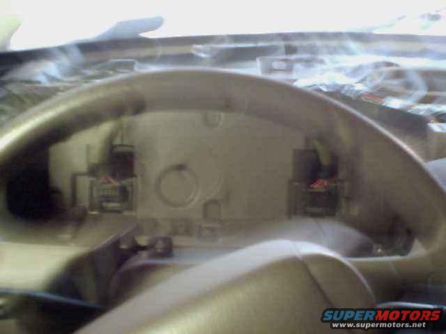 Dashboard wiring harness with connectors and red and black wires visible