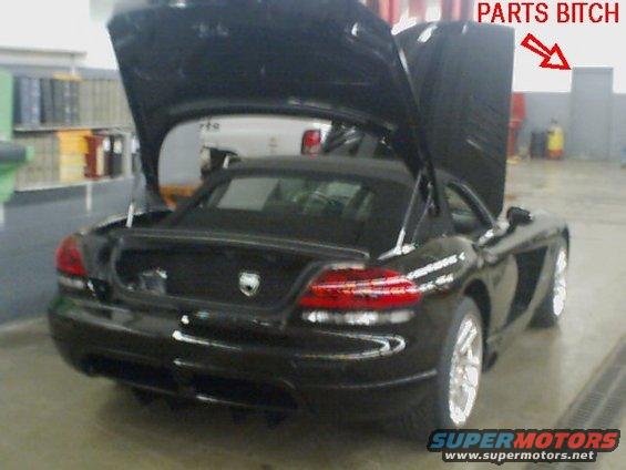 Black sports car with open hood and trunk, showing interior. Text overlay says 'PARTS BITCH'