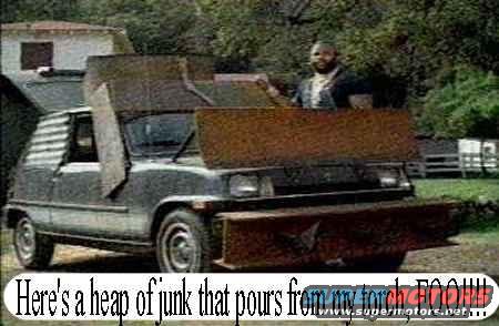 Modified car with large metal plates attached to the front and hood, a man stands behind it