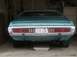 1993 Ford Bronco - Rear view of a teal 1971 Dodge Charger, its distinctive horizontal taillights and chrome bumper.