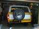 1978 Ford Bronco - The rear of a classic Ford Bronco is shown, parked inside a garage with the door open.