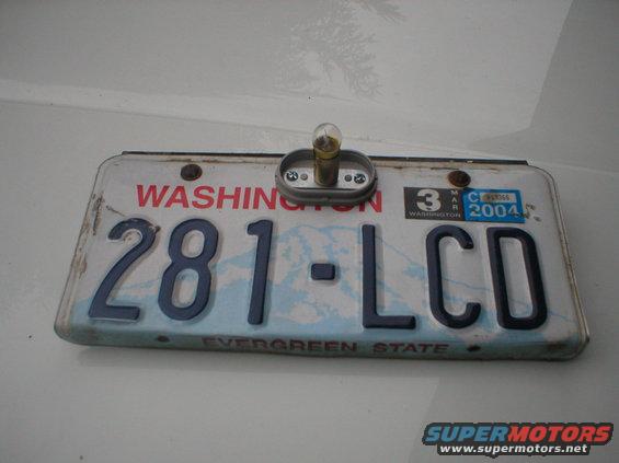 Washington license plate 281-LCD with March 2004 sticker and a license plate light