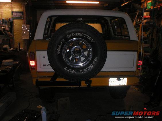 Yellow and white 1978 Ford Bronco rear view with spare tire and license plate