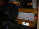 1978 Ford Bronco - The rear of a yellow and white SUV, a spare tire mounted on the tailgate and a license plate.