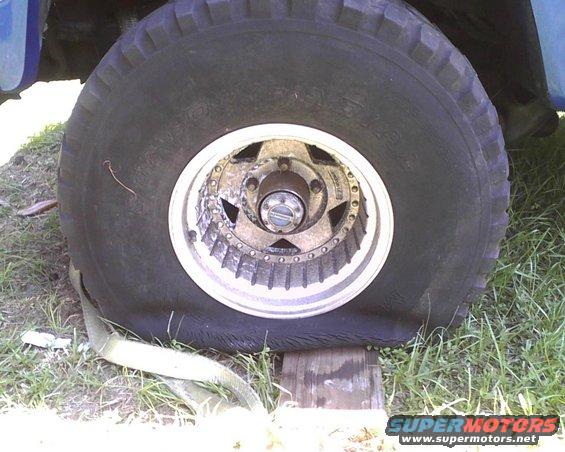 Flat tire on a vehicle, supported by wood blocks