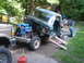 1979 Ford Bronco - Pickup truck cab undergoing work, with engine removed and supported by ramps.