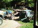 1979 Ford Bronco - Truck parts are laid out in a yard with a shed and trees in the background.