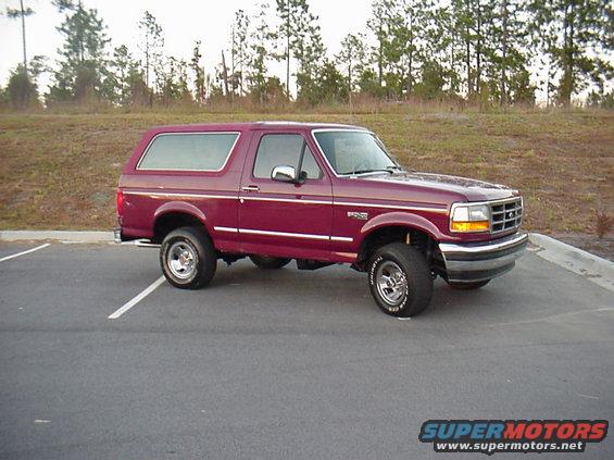 Maroon Ford Bronco parked in a lot. It's a 1993 model