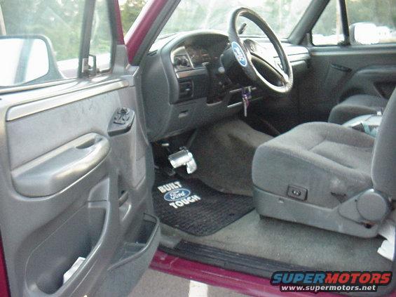 1993 Ford Bronco interior showing driver's seat, dashboard, steering wheel, and door panel