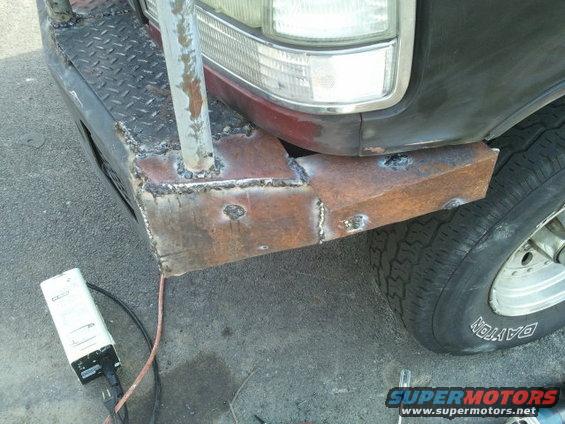Custom welded bumper on a red 1992 Ford Bronco, front driver side