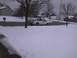 2003 Ford Crown Victoria - A white pickup truck sits on a snow-covered road with its hood open.
