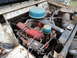 1962 International Scout 80 - The engine compartment of a vehicle, showing the engine block, air filter, and associated components.