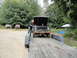 1962 International Scout 80 - A man loads a 1962 International Scout 80 onto a trailer, with two other similar vehicles visible in the background.