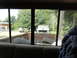 1962 International Scout 80 - View from inside a vehicle shows a classic International Scout parked in a yard with another SUV in the background.